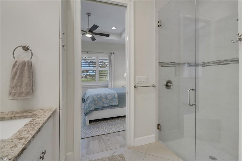 5782 Highbourne Drive Naples, FL 34113 - Photo 11 of 31 a en suite bathroom with a granite countertop shower
