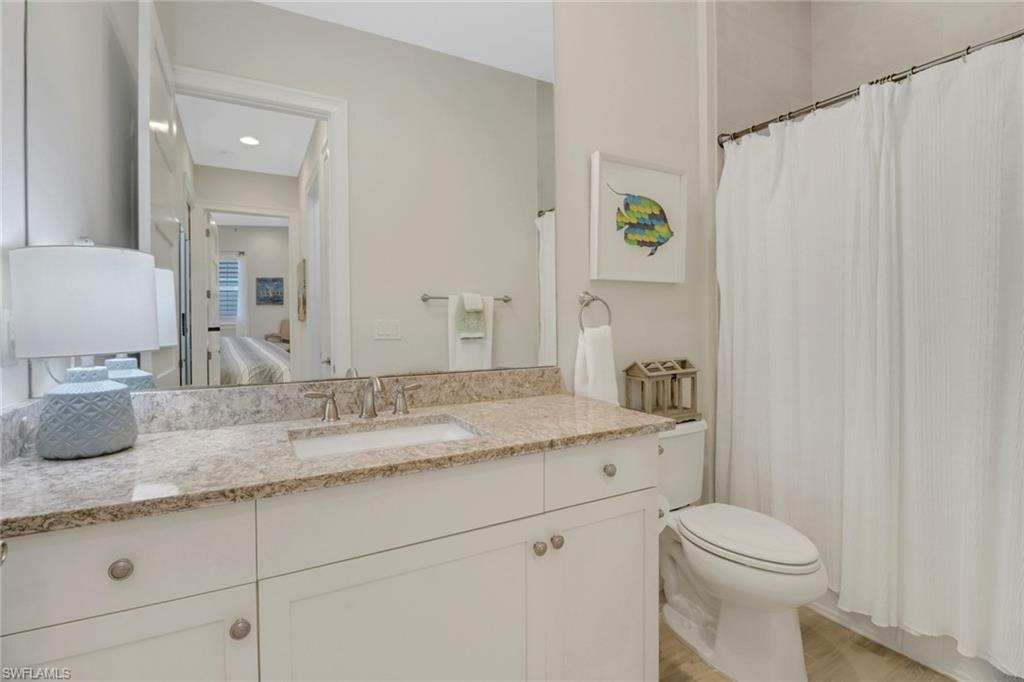 5782 Highbourne Drive Naples, FL 34113 - Photo 15 of 31 a bathroom with a granite countertop sink and a mirror