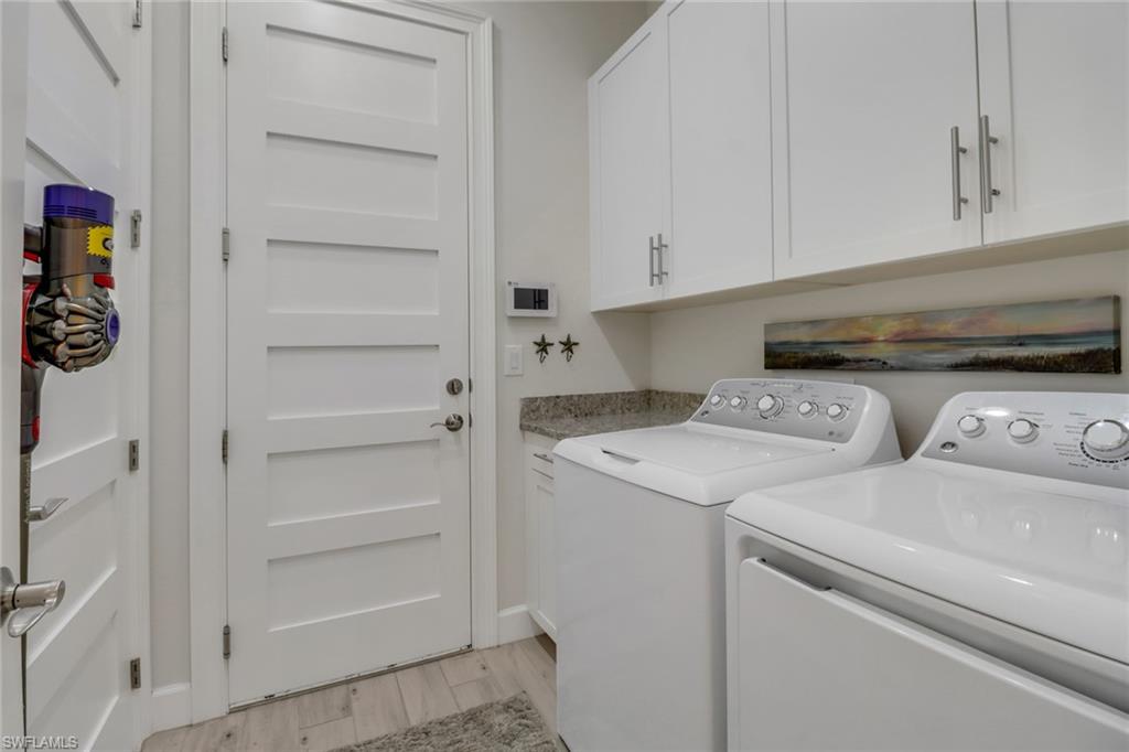 5782 Highbourne Drive Naples, FL 34113 - Photo 16 of 31 a utility room with dryer and washer