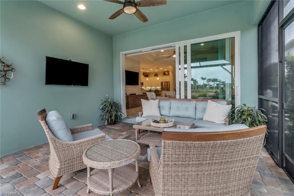 5782 Highbourne Drive Naples, FL 34113 - Photo 18 of 31 a living room with furniture and a flat screen tv
