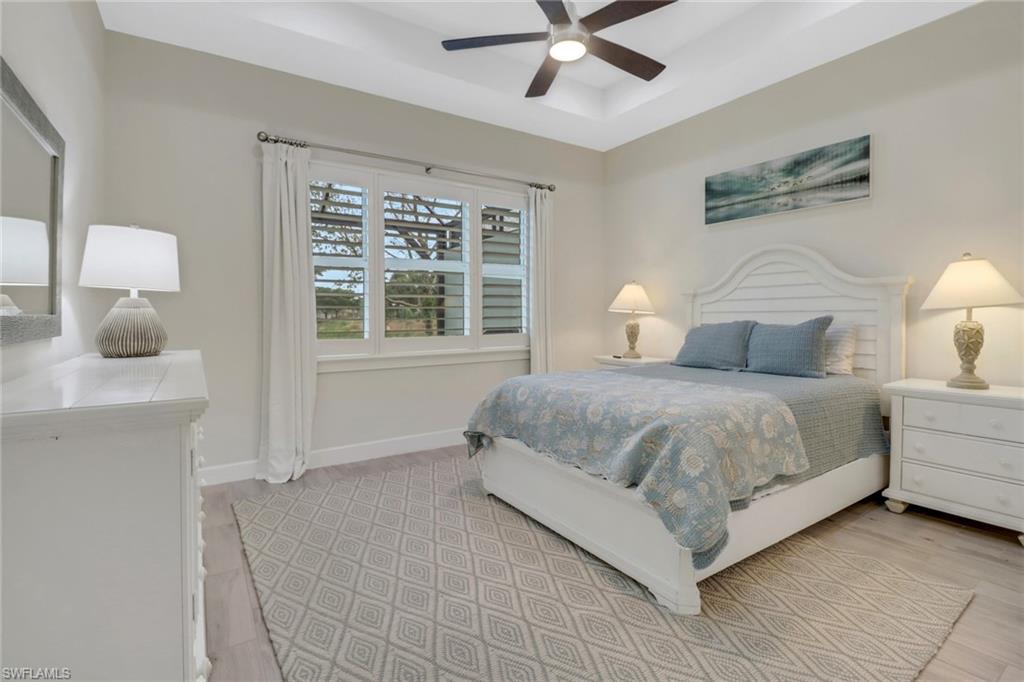 5782 Highbourne Drive Naples, FL 34113 - Photo 8 of 31 a bedroom with a large bed and a window