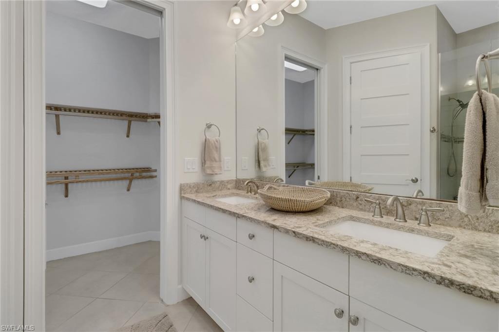 5782 Highbourne Drive Naples, FL 34113 - Photo 10 of 31 a bathroom with a granite countertop sink and a mirror