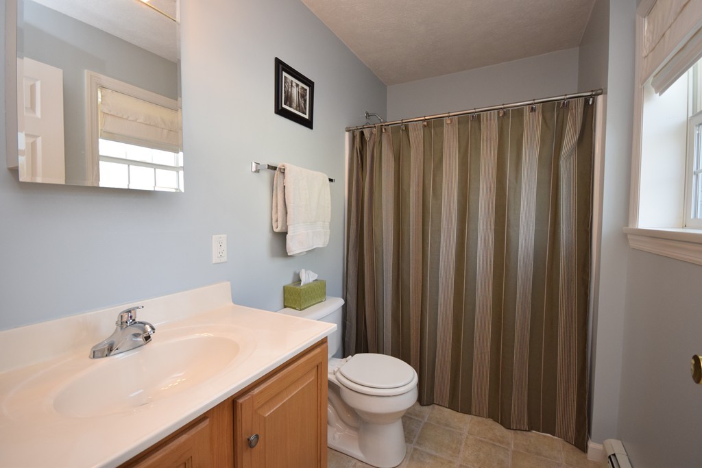 142 Benz Street Springfield, MA 01118 - Photo 11 of 30 a bathroom with a sink a toilet and shower curtain