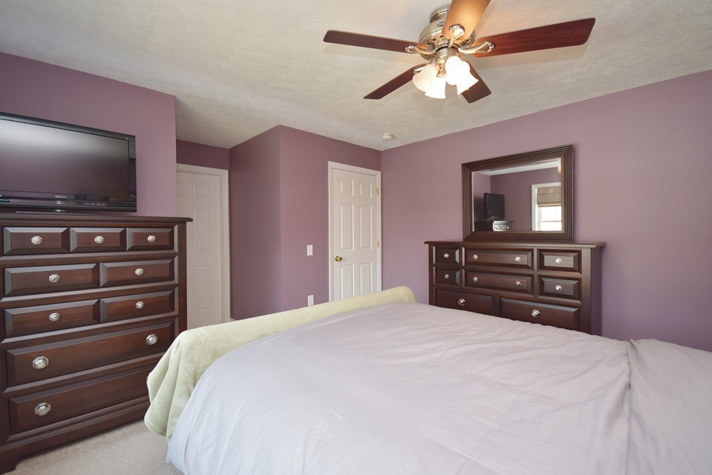 142 Benz Street Springfield, MA 01118 - Photo 21 of 30 a bedroom with a bed and a flat screen tv