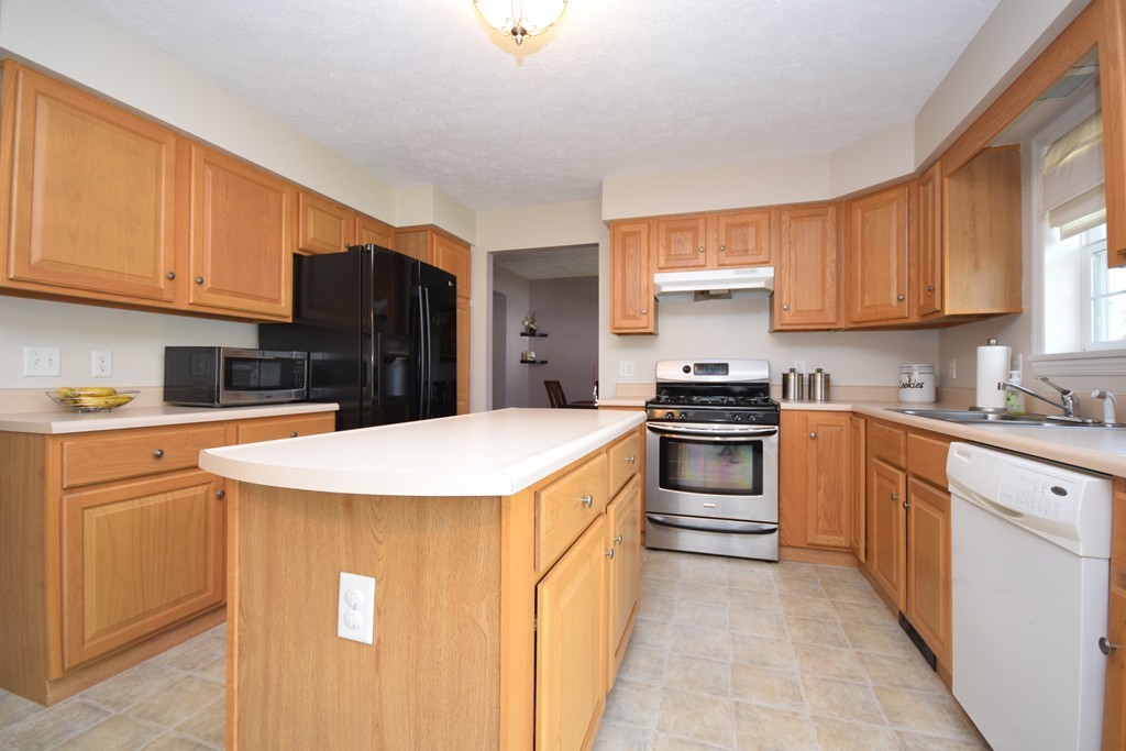 142 Benz Street Springfield, MA 01118 - Photo 3 of 30 a kitchen with stainless steel appliances and white cabinets