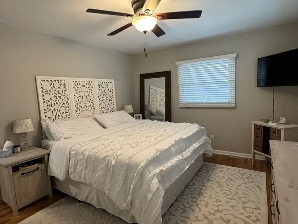 a bedroom with a bed and a flat screen tv