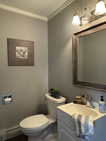 a bathroom with a sink a toilet and mirror