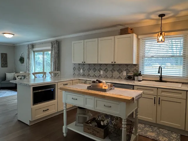 a kitchen with a sink cabinets and window