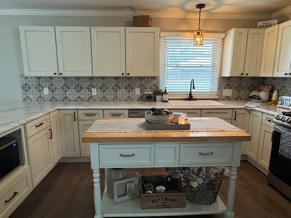 a kitchen with a sink cabinets and window