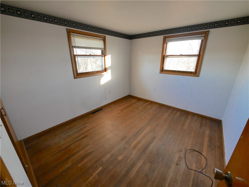 61784 Ray Ramsey Road Shadyside, OH 43947 - Photo 19 of 29 Unfurnished room with hardwood / wood-style floors