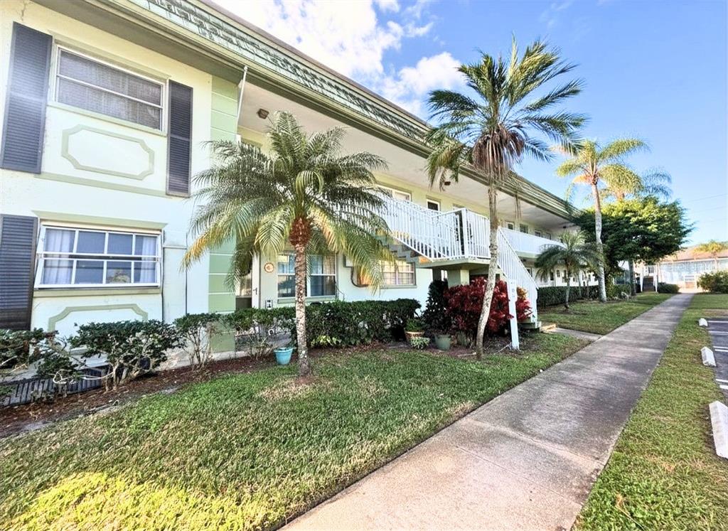 1433 South Belcher Road, Unit B2 Clearwater, FL 33764 - Photo 1 of 20 a group of people sitting in front of a building