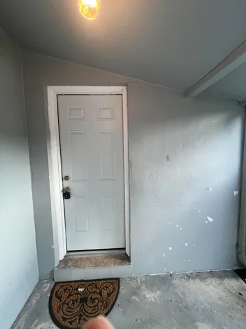 an empty room with wooden floor and a window