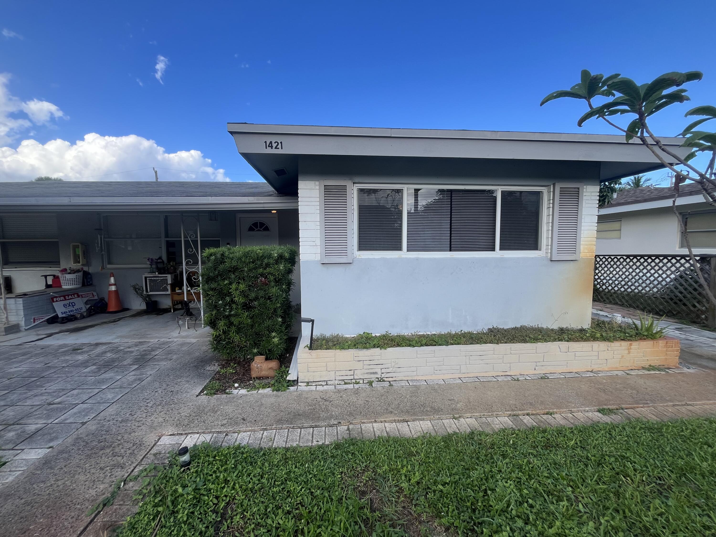 1421 Southeast 2nd Street, Unit E Deerfield Beach, FL 33441 - Photo 9 of 9 a front view of a house with garden