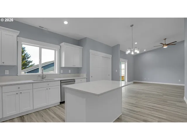 a kitchen with a sink cabinets and window