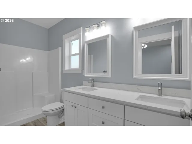 a bathroom with a sink a toilet and a mirror