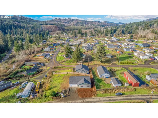 a view of residential houses with outdoor space and parking