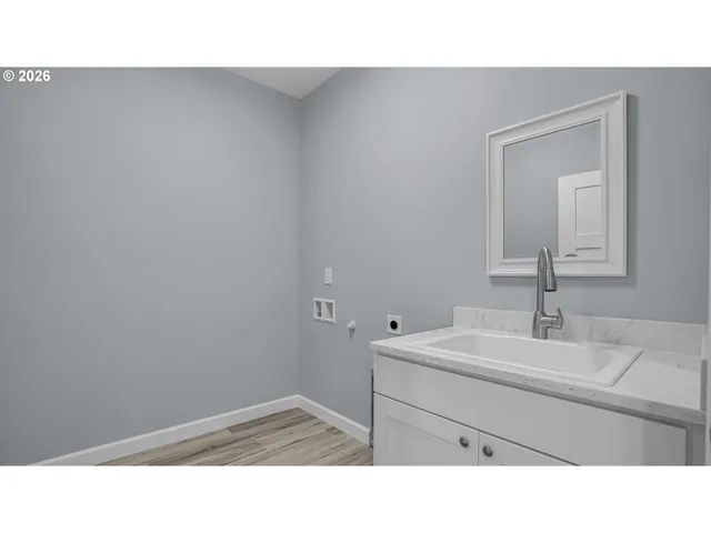 a bathroom with a sink vanity and a mirror