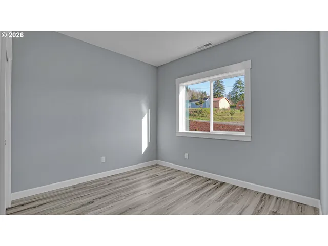 a room with a window and a ceiling fan