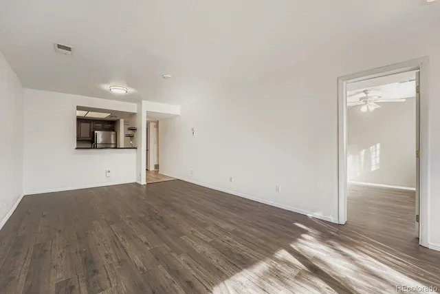 a view of a room with wooden floor and a sink