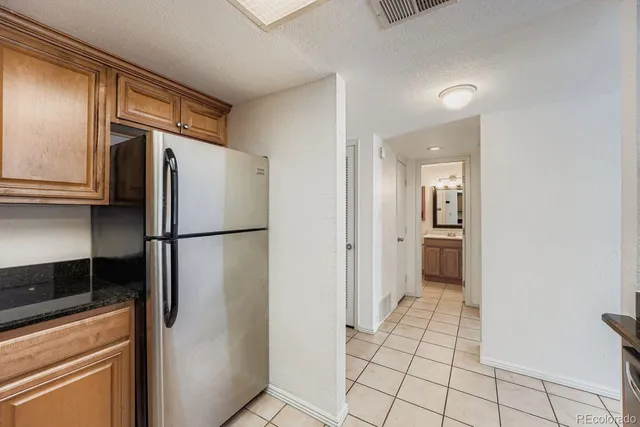 a kitchen with a refrigerator and cabinets