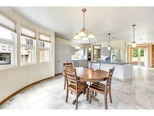 a dining room with furniture a chandelier and wooden floor
