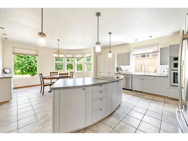a open kitchen with stainless steel appliances kitchen island granite countertop a sink cabinets and window
