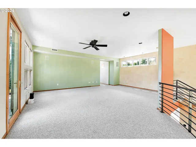 a view of a livingroom with an empty space and windows