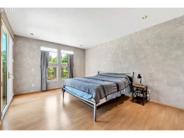 a bedroom with a large bed and a large window