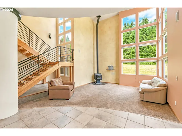 a living room with couch and a large window