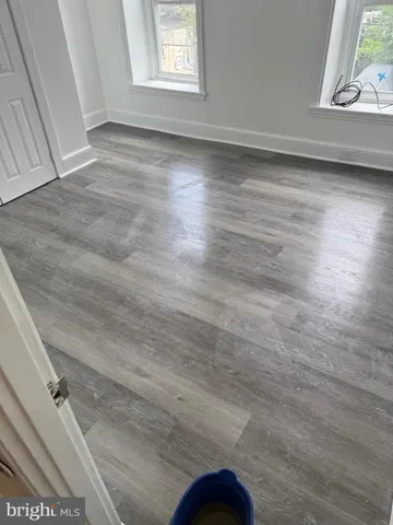 a view of a room with wooden floor and window