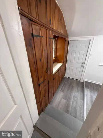 a view of a hallway and staircase with wooden floor