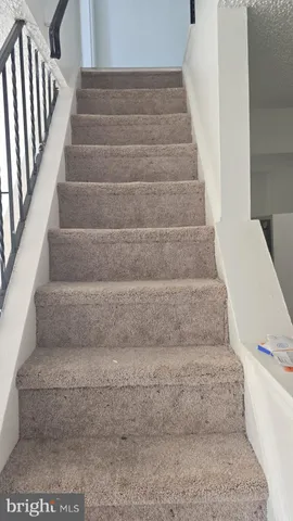 a view of staircase with white walls
