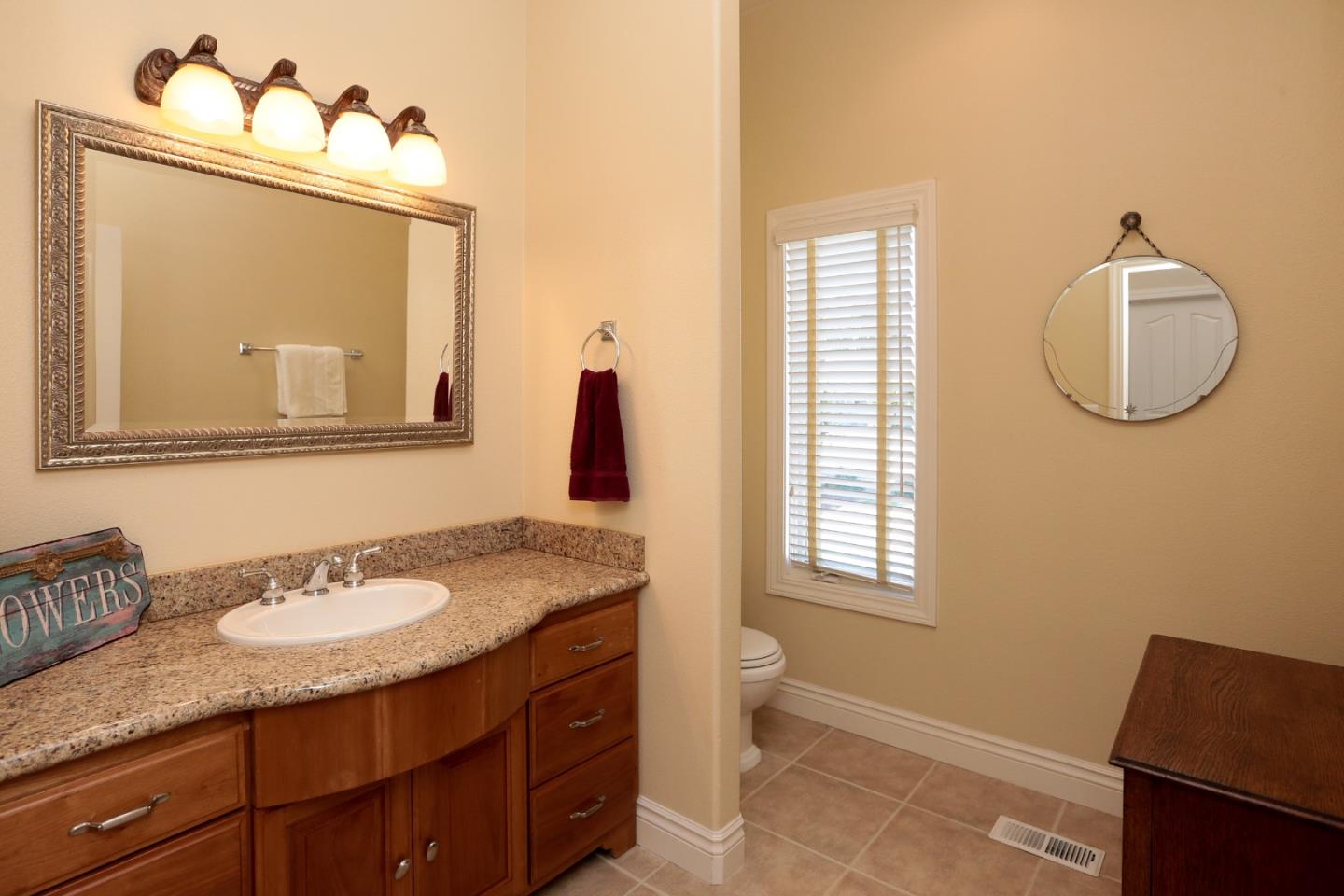1068 Audrey Avenue Campbell, CA 95008 - Photo 12 of 47 a bathroom with a granite countertop sink mirror and a window