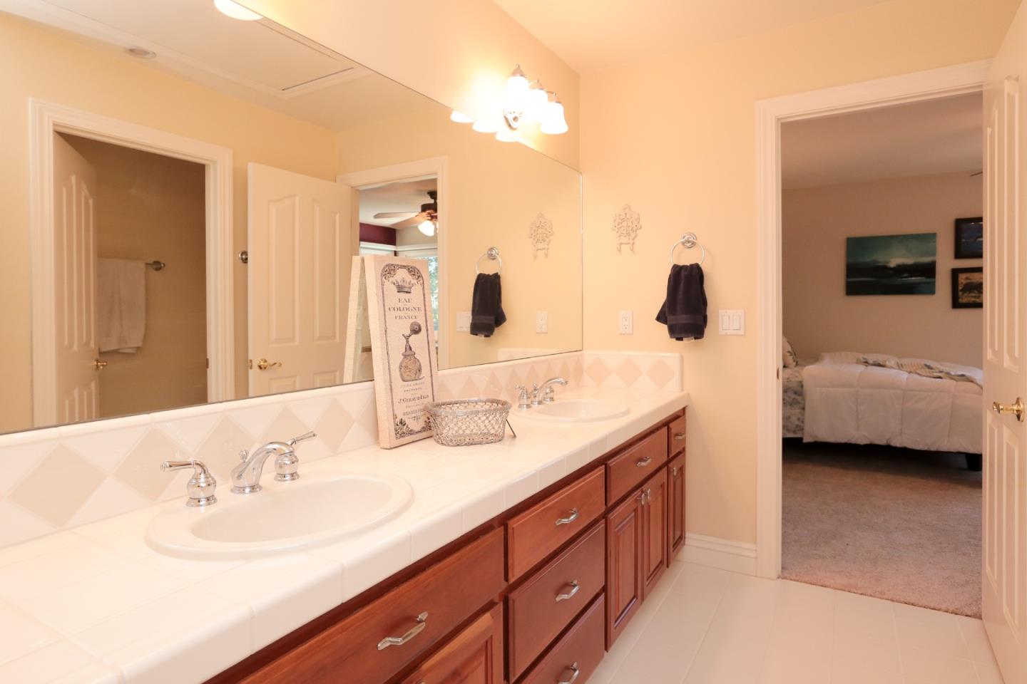 1068 Audrey Avenue Campbell, CA 95008 - Photo 25 of 47 a en suite bathroom with a double vanity sink and mirror