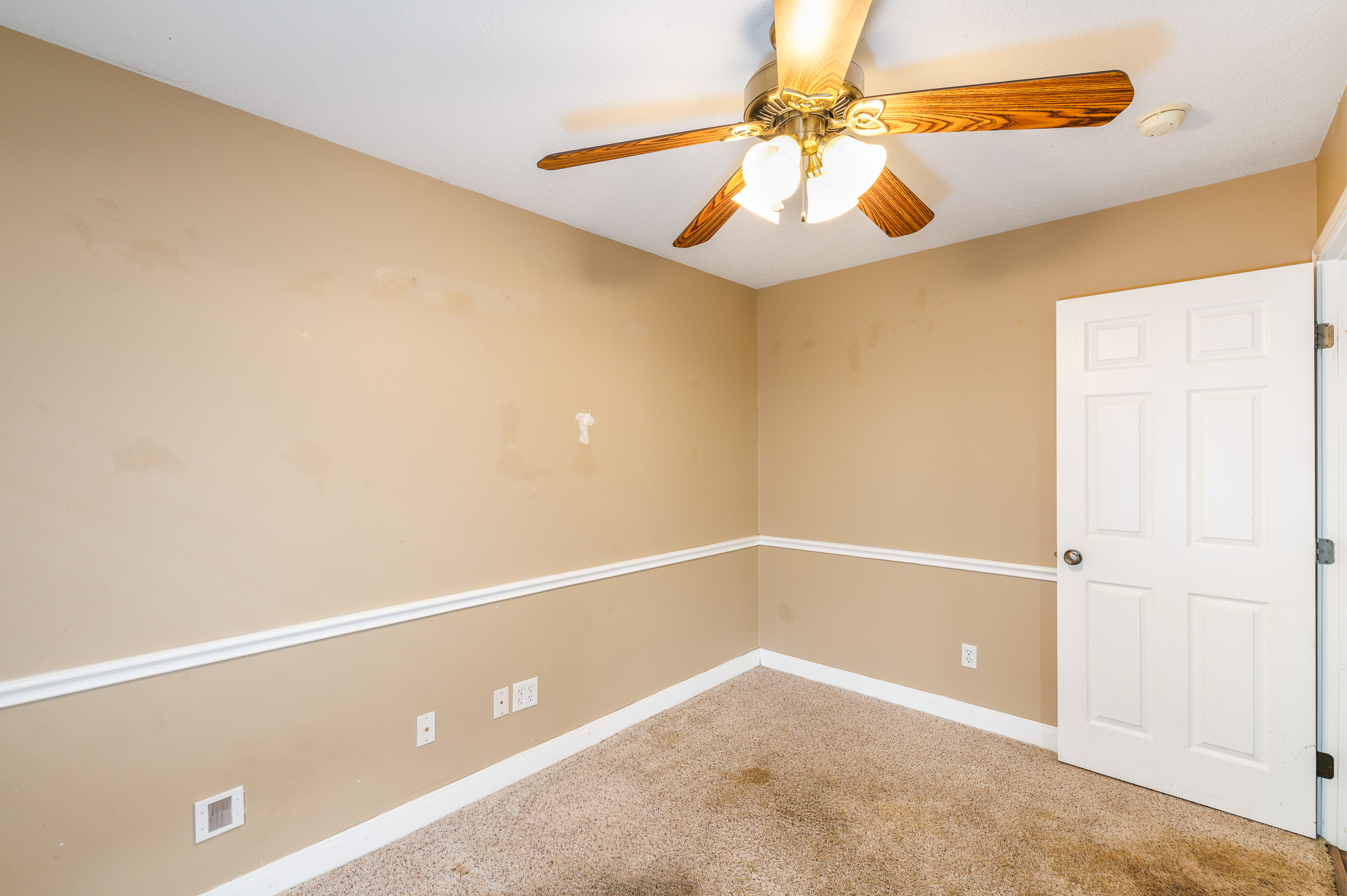 1710 Harwood Road Luling, TX 78648 - Photo 27 of 30 Plush carpeting and classic chair rail molding define this versatile secondary room.