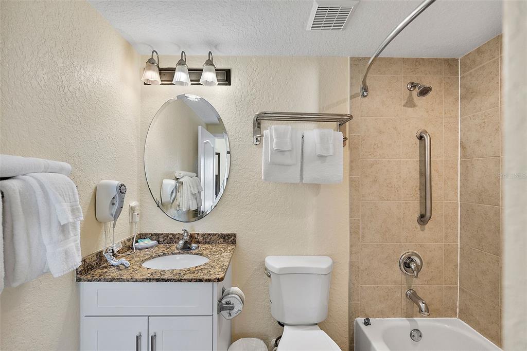 12000 Gulf Boulevard, Unit 501W Treasure Island, FL 33706 - Photo 25 of 36 a bathroom with a toilet sink and mirror