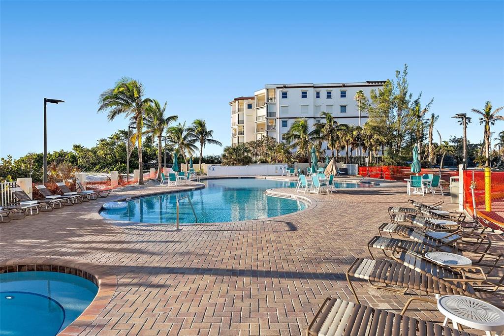 12000 Gulf Boulevard, Unit 501W Treasure Island, FL 33706 - Photo 4 of 36 a view of a swimming pool with a lawn chairs