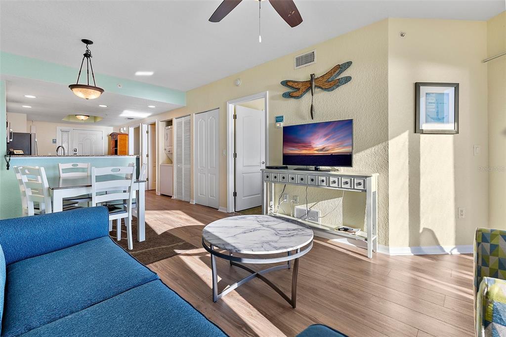 12000 Gulf Boulevard, Unit 501W Treasure Island, FL 33706 - Photo 5 of 36 a living room with furniture a dining table and a fireplace