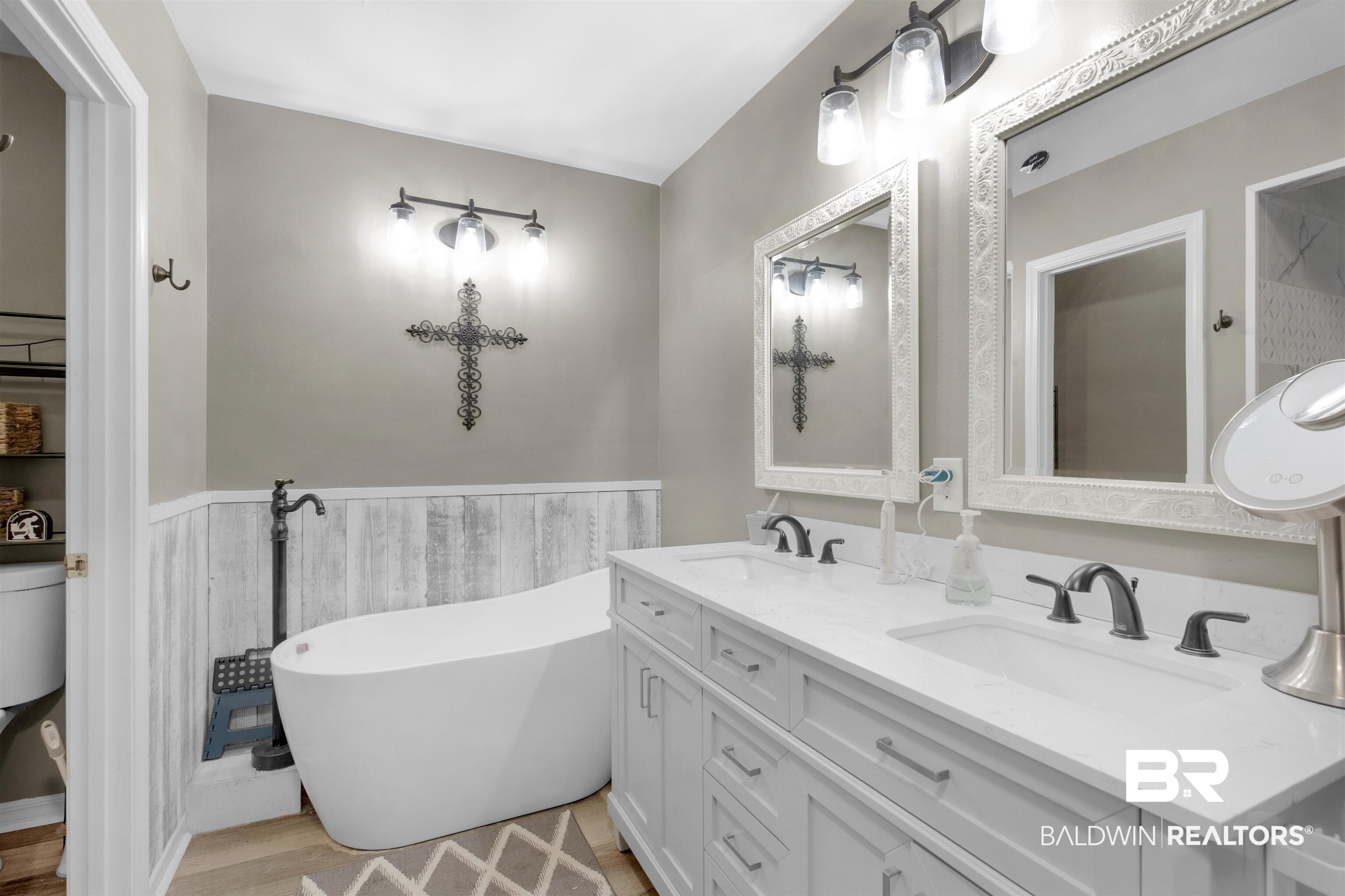 13925 Fort Lake Road Grand Bay, AL 36541 - Photo 13 of 37 Full bathroom featuring double vanity, a sink, a freestanding tub, and wood finished floors