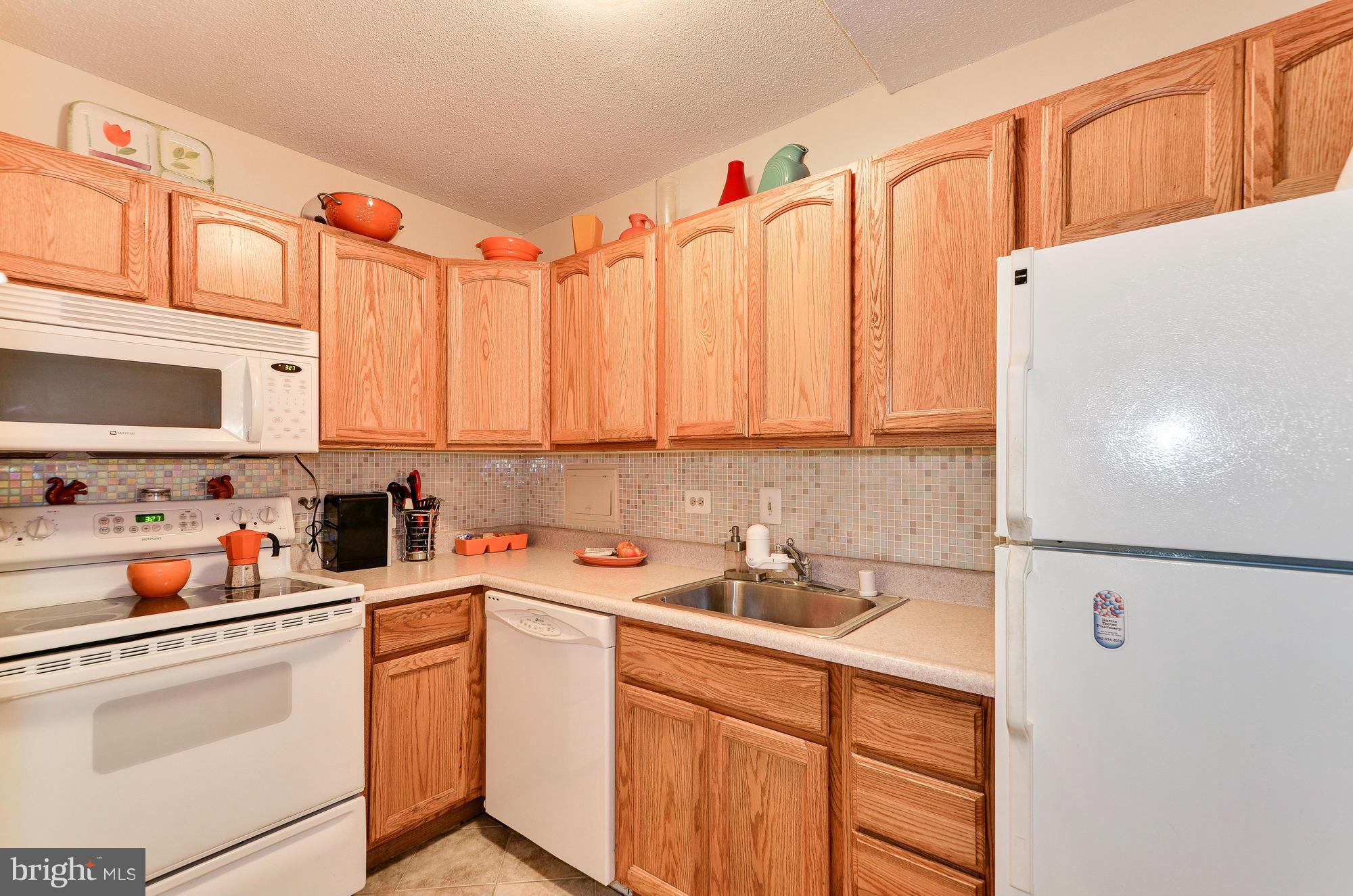 1301 Delaware Avenue Southwest, Unit N523 Washington, DC 20024 - Photo 11 of 26 a kitchen with stainless steel appliances a sink and cabinets