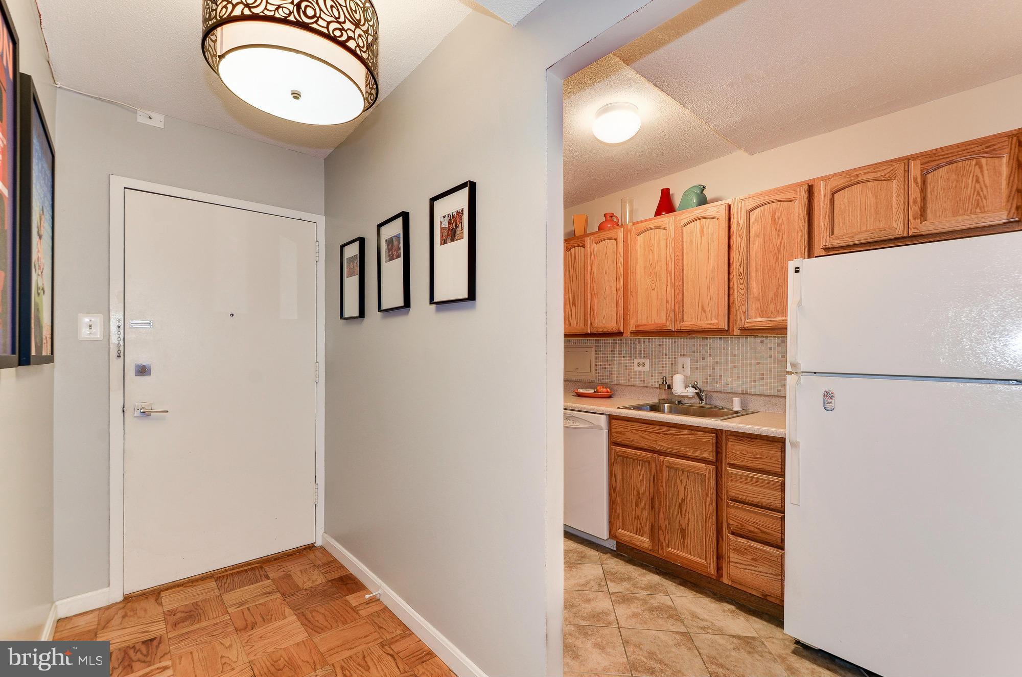 1301 Delaware Avenue Southwest, Unit N523 Washington, DC 20024 - Photo 4 of 26 a kitchen with a refrigerator a stove top oven a sink and dishwasher