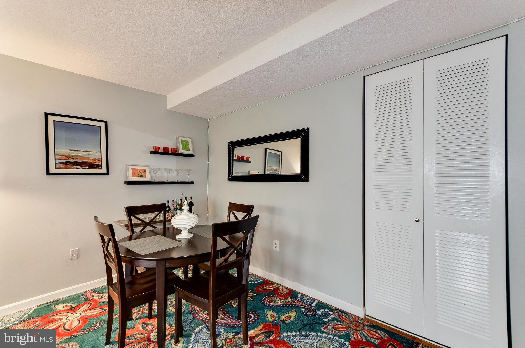 1301 Delaware Avenue Southwest, Unit N523 Washington, DC 20024 - Photo 9 of 26 a view of a dining room with furniture and wooden floor