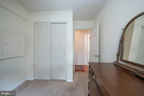 a bathroom with a granite countertop sink a toilet and a mirror