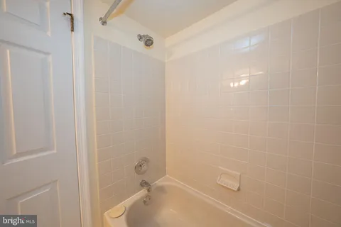 a bedroom with a bed and a chair