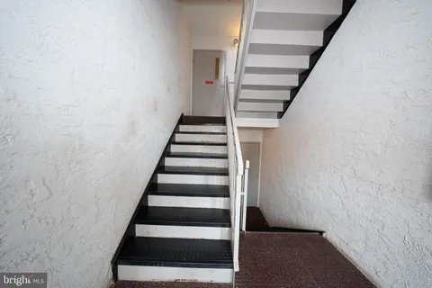 a wooden bench sitting in front of a building