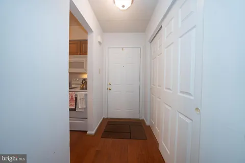 a kitchen with granite countertop a sink stove and cabinets