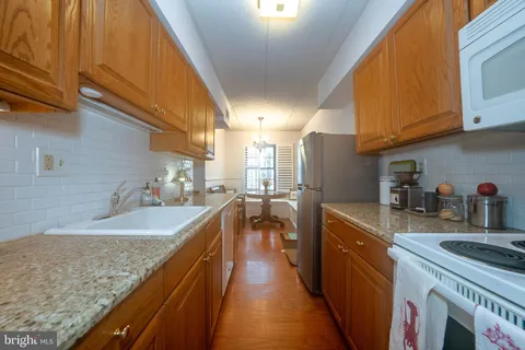 a kitchen with stainless steel appliances granite countertop a sink and cabinets
