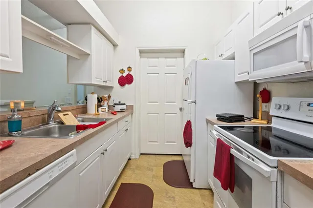 a kitchen with a sink stove and refrigerator