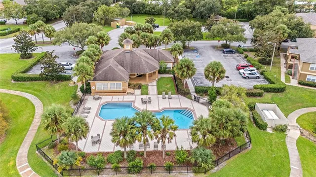 an aerial view of residential houses with outdoor space and swimming pool