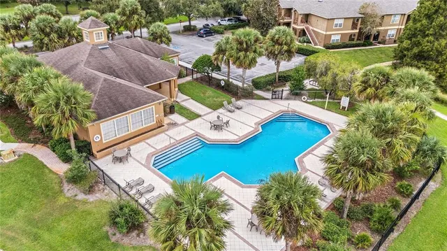 an aerial view of a house with garden space and lake view